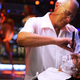 A man getting a shave from a barber at a strip club